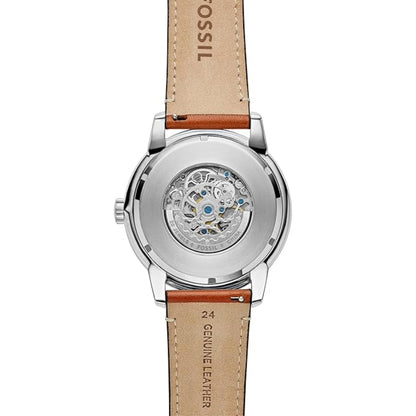 Fossil watch with brown leather strap on a white background