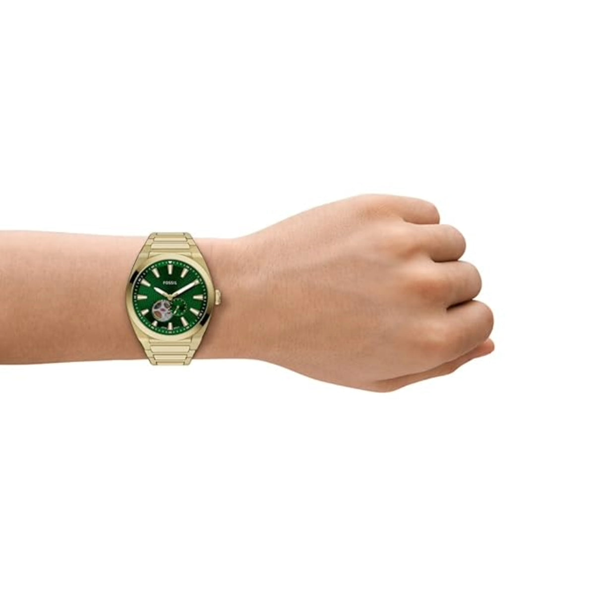 Gold watch with a green face on a wrist against a white background