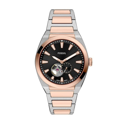 Fossil watch with two-tone rose gold and silver band on white background