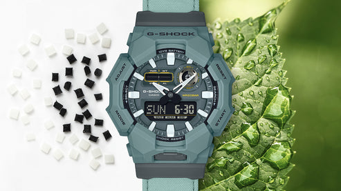 Green G-Shock watch with digital display on a white background with black and white checkered pattern
