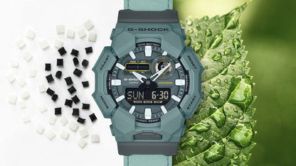 Green G-Shock watch with digital display on a white background with black and white checkered pattern