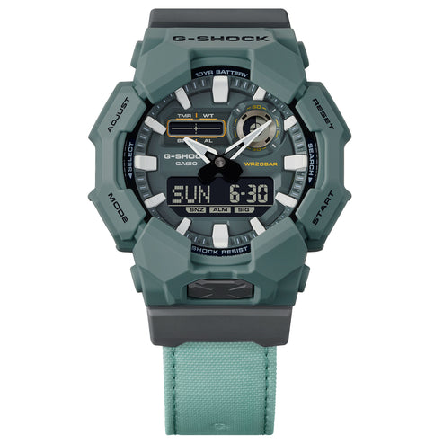 Green Casio G-Shock watch with digital and analog display on a white background