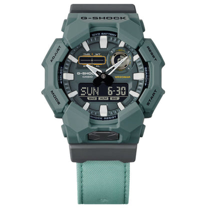 Green Casio G-Shock watch with digital and analog display on a white background