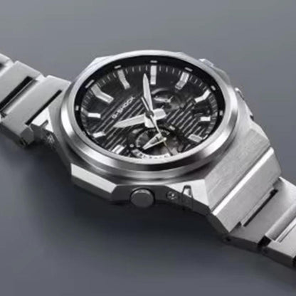 Silver wristwatch with a detailed face on a gray background