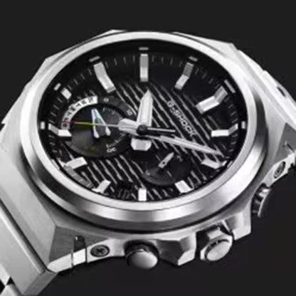 Silver watch with a black face on a black background