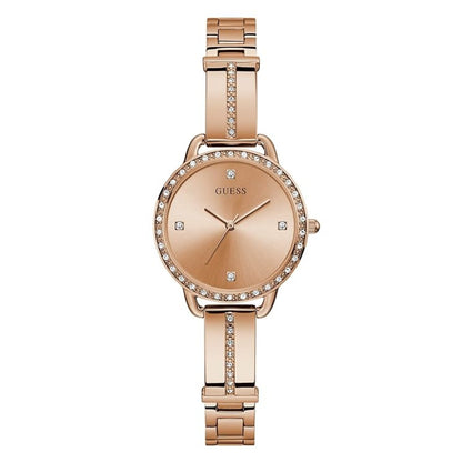 A rose gold Guess watch with a metal link bracelet, crystal-accented bezel and center band, and crystal hour markers on a white background.