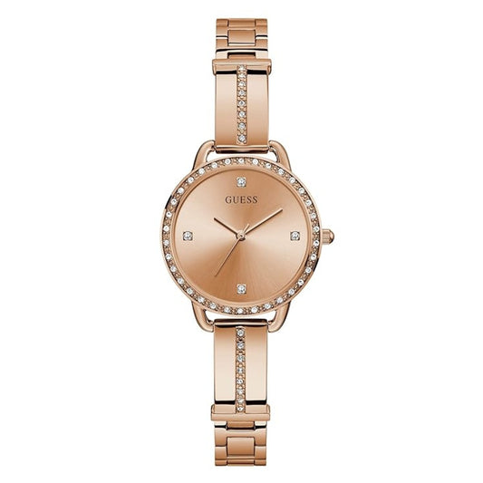 A rose gold Guess watch with a metal link bracelet, crystal-accented bezel and center band, and crystal hour markers on a white background.