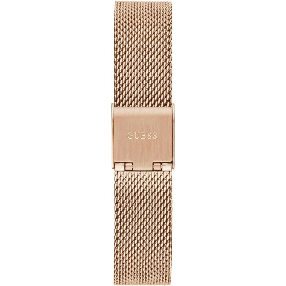 Rose gold mesh watch band with 'GUESS' logo on a white background