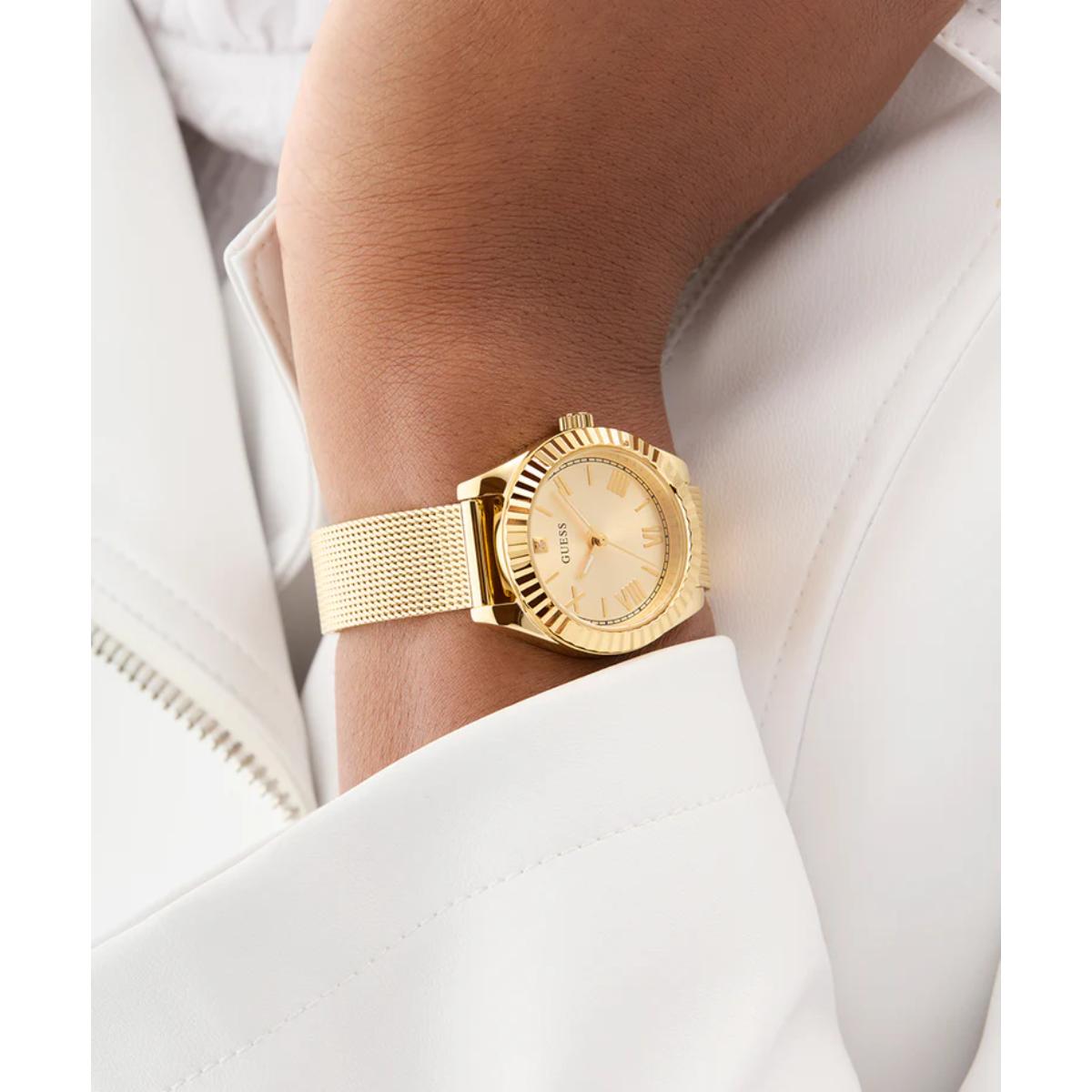 Gold watch on a wrist with a white background