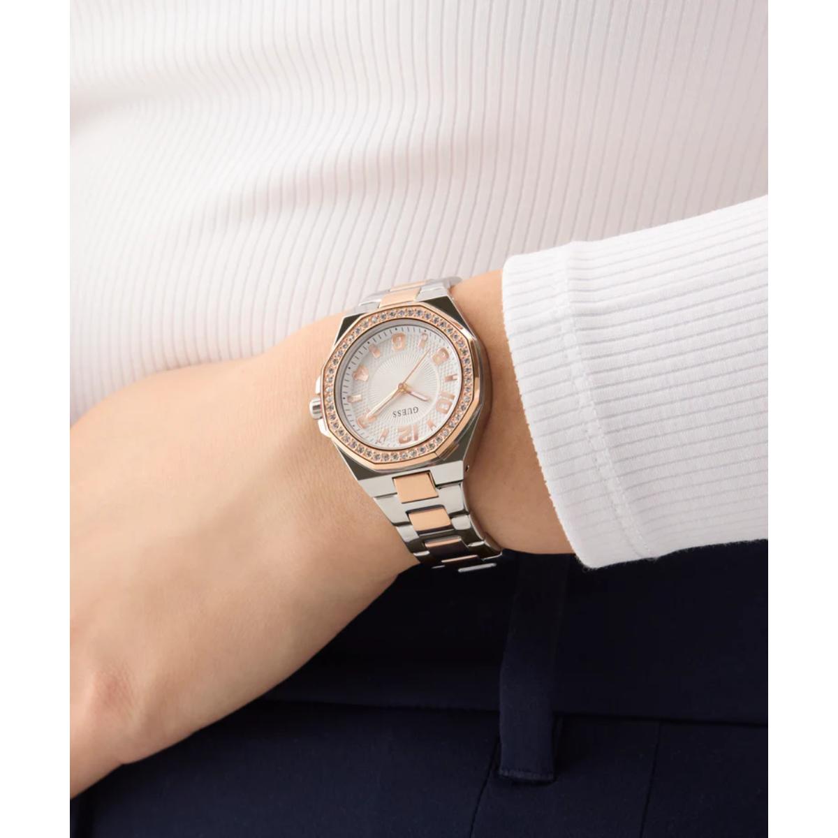 Silver and rose gold watch on a wrist with a white background