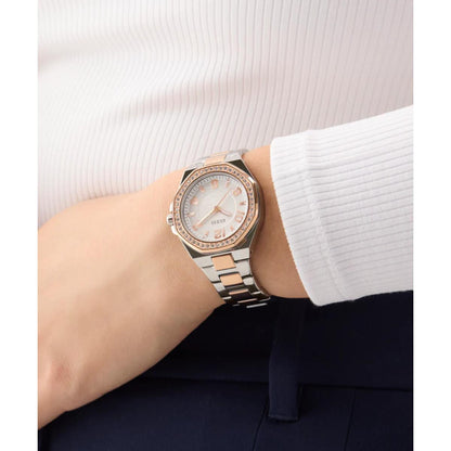 Silver and rose gold watch on a wrist with a white background