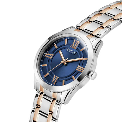 Guess watch with blue dial and rose gold accents on a white background