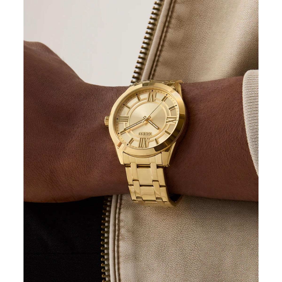 Gold wristwatch on a person's wrist with a neutral background