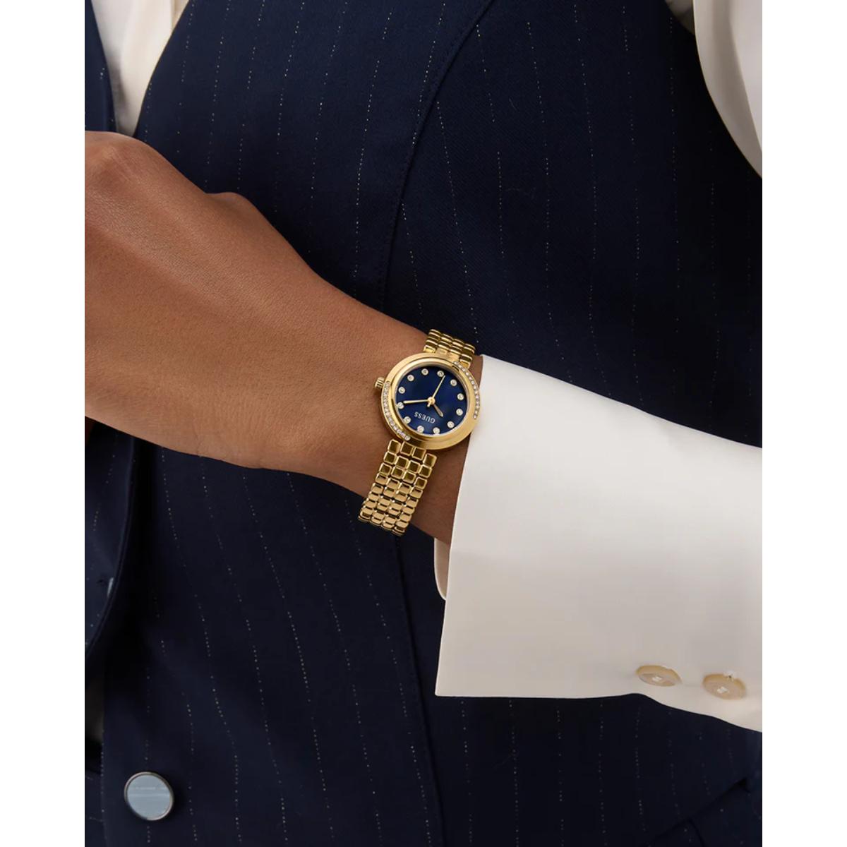 Gold watch on a wrist with a suit background