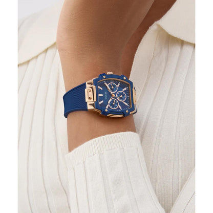 Blue watch with gold accents on a wrist against a white background