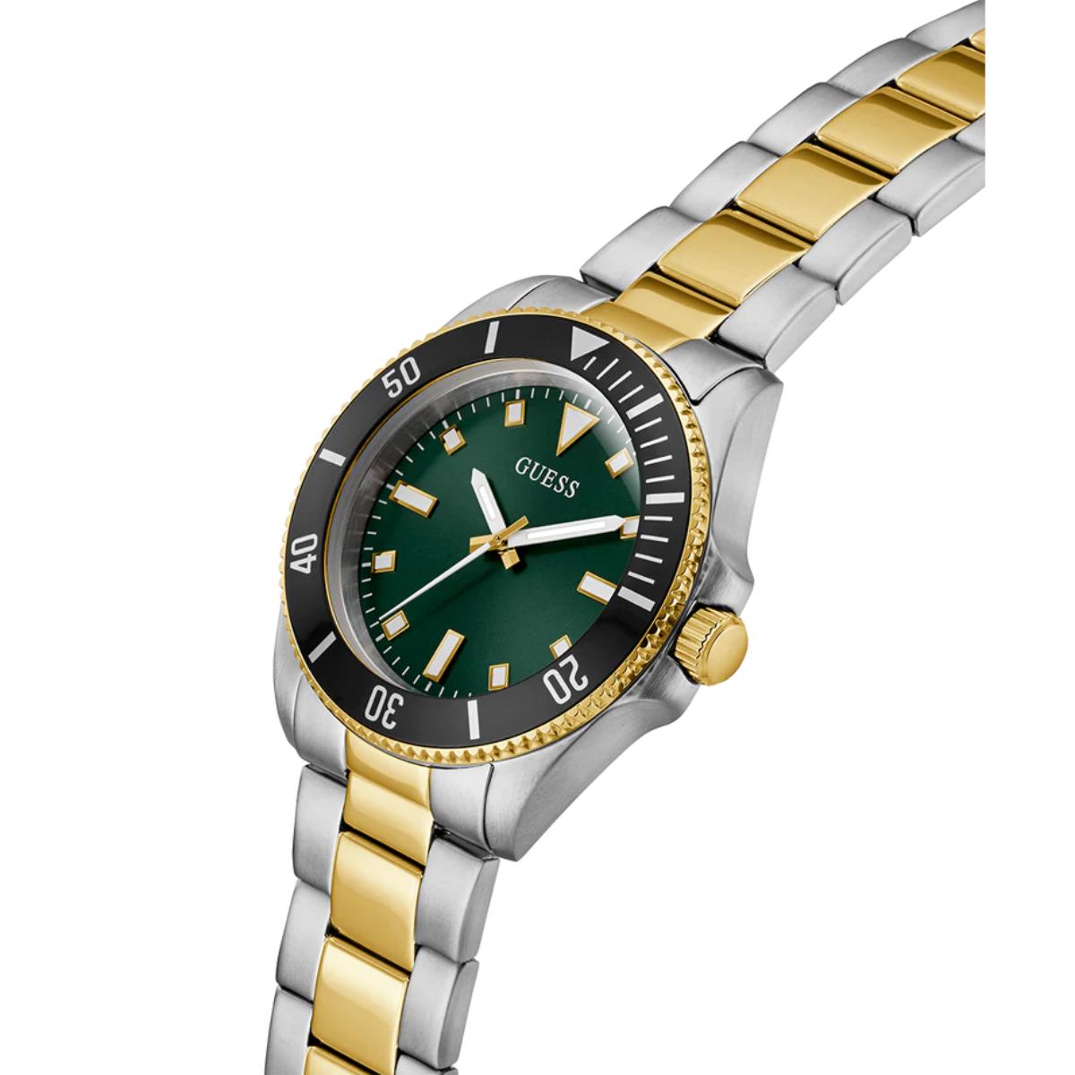 A Guess women's two-tone stainless steel and gold watch with a green dial and black bezel, shown on a white background.
