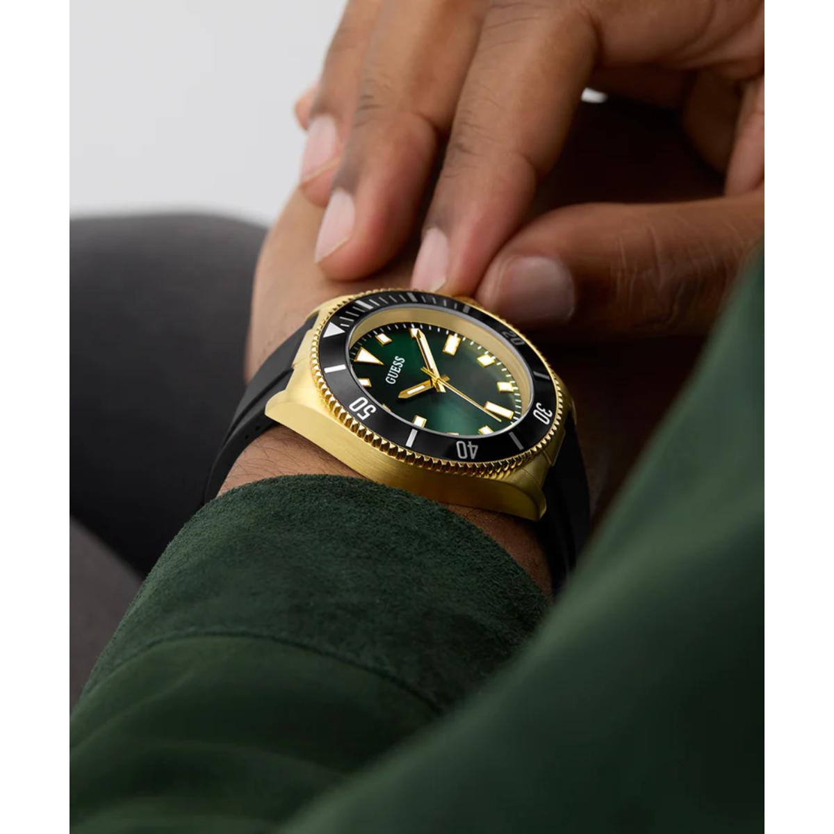 Gold and black watch on a wrist with a blurred background