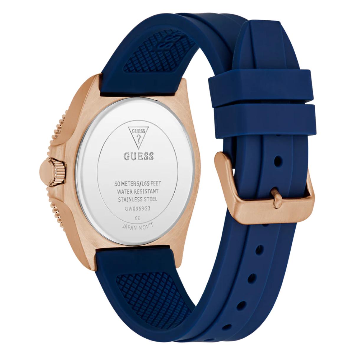 Guess watch with blue strap and rose gold case on a white background