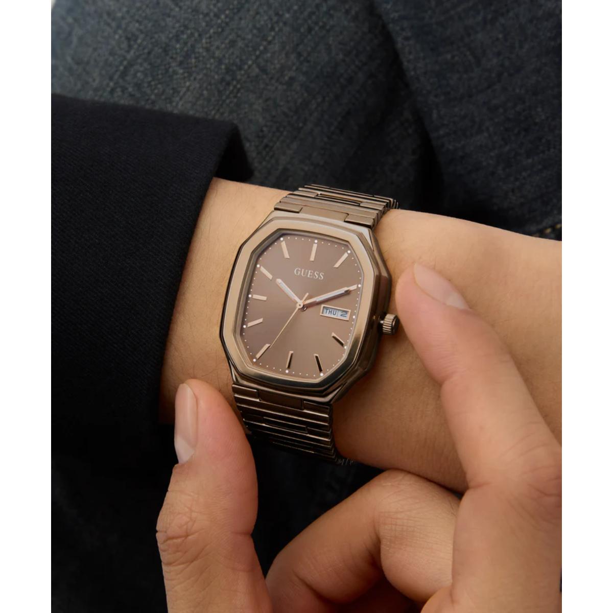 Person wearing a Guess watch on their wrist with a close-up view.