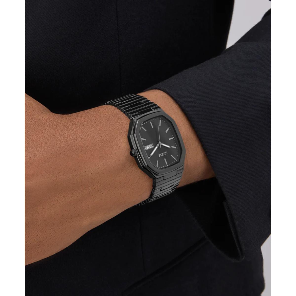 Black watch on a person's wrist with a blurred background