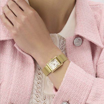 Gold watch on a wrist with a pink coat