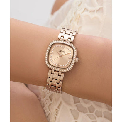 Rose gold watch on a wrist with a lace background