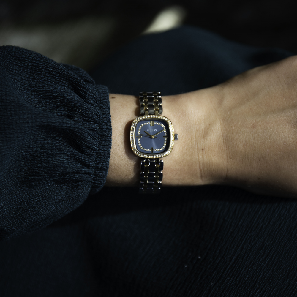 Watch on a wrist with a dark background