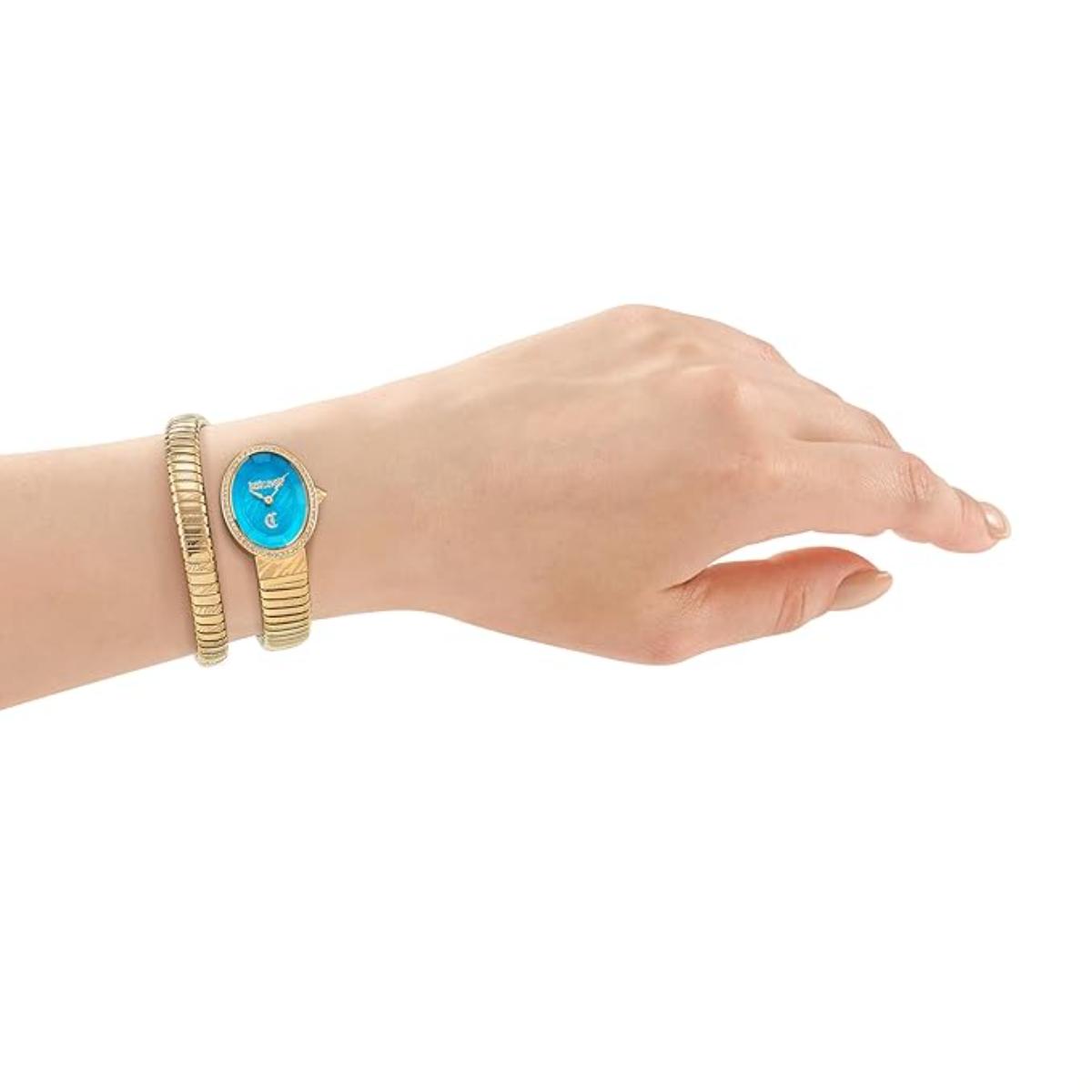 Hand wearing a gold watch with a blue face on a white background