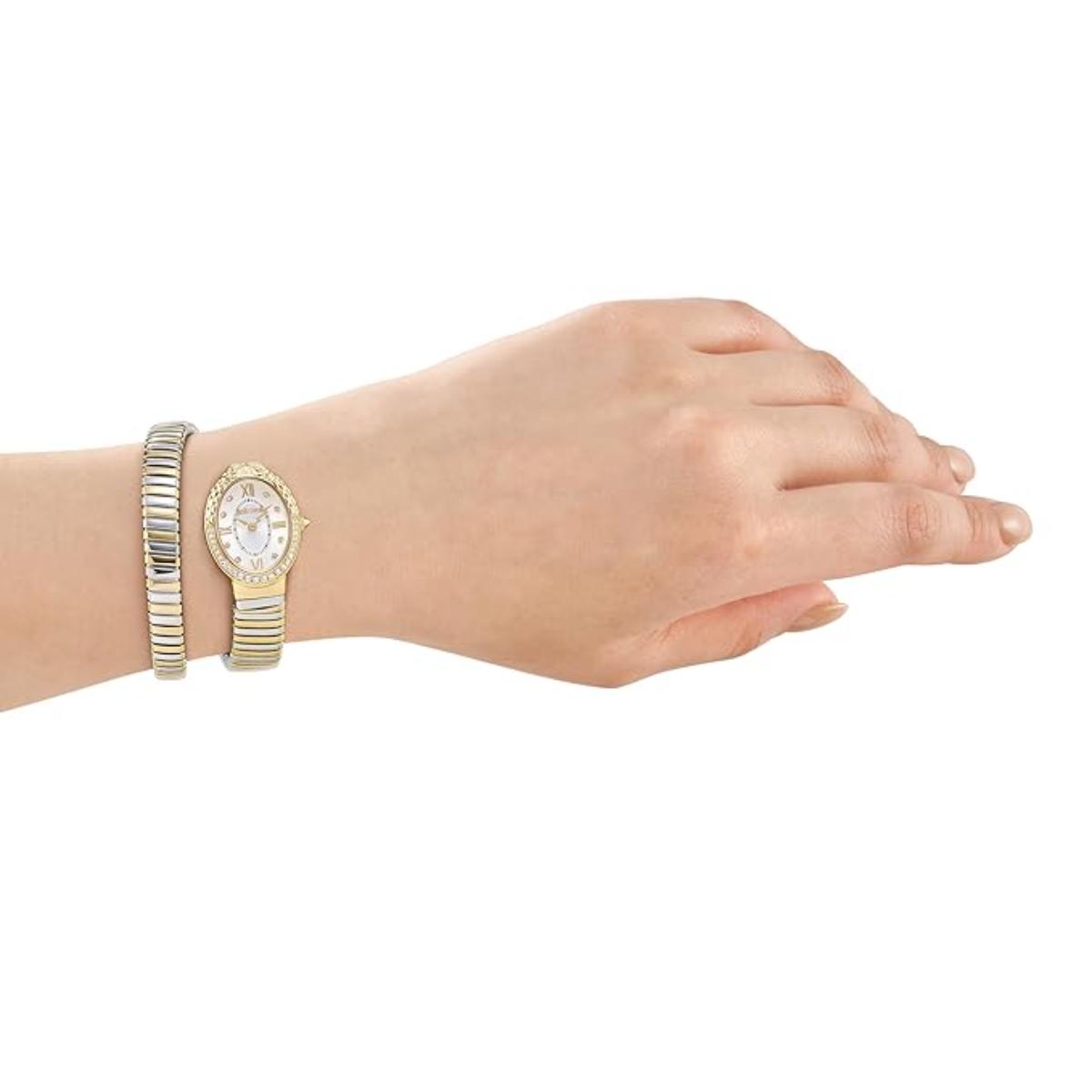 Gold watch and bracelet on a wrist against a white background