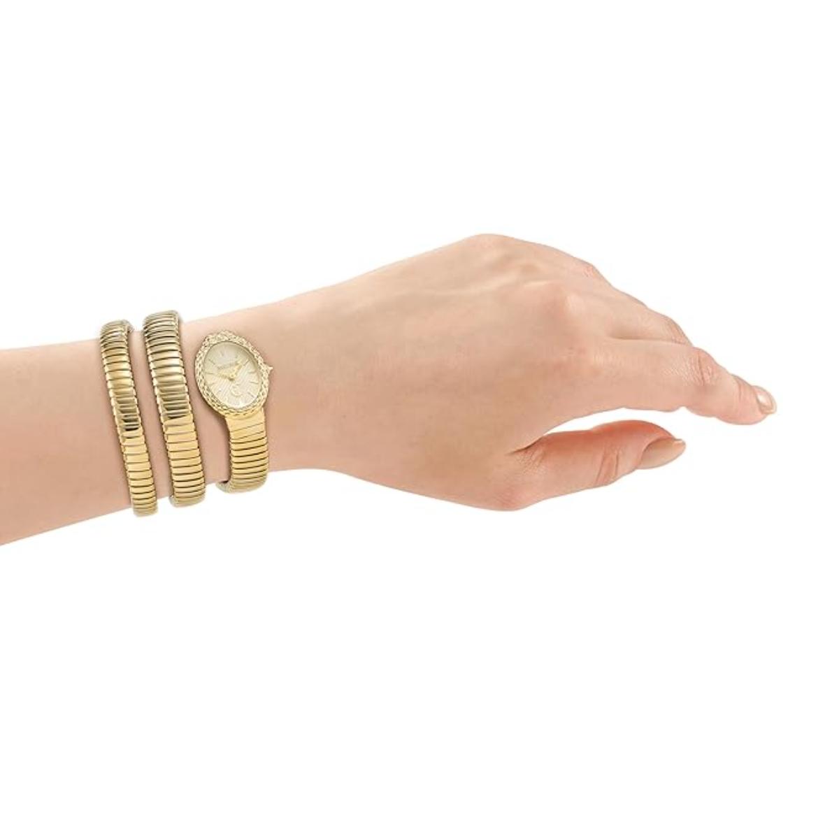 Hand wearing a gold watch and bracelets on a white background