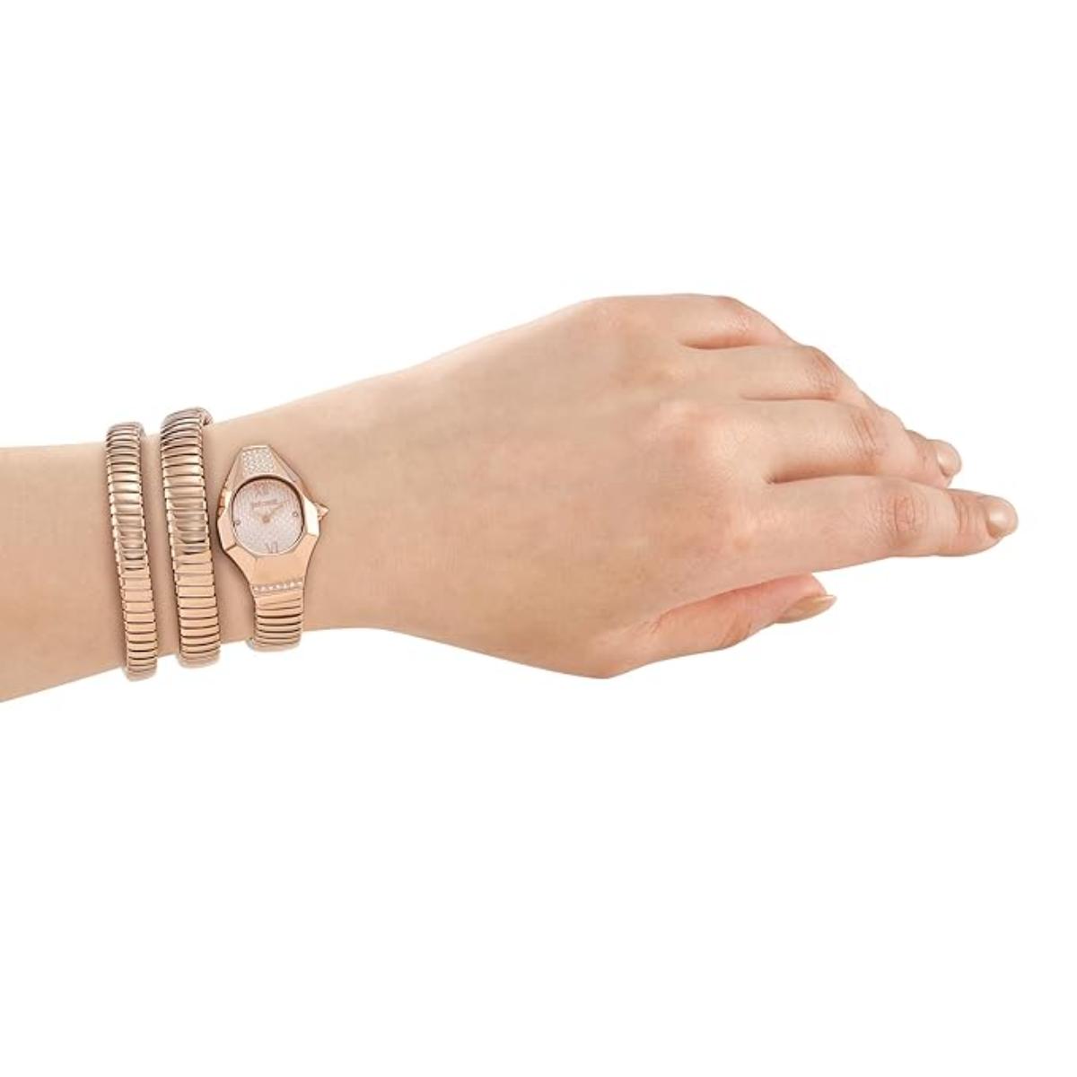 Hand wearing a rose gold watch and bracelets on a white background