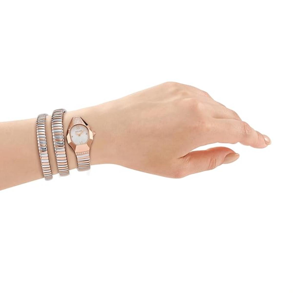 Hand wearing a rose gold watch with multiple bracelets on a white background