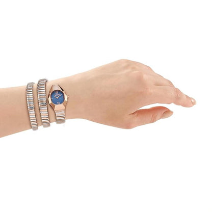 Hand wearing a watch with multiple bracelets on a white background