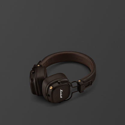 Brown headphones with Marshall logo on a dark gray background