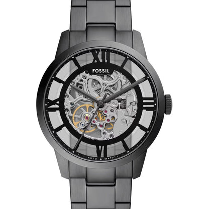 Fossil watch with metallic band and transparent face on a white background