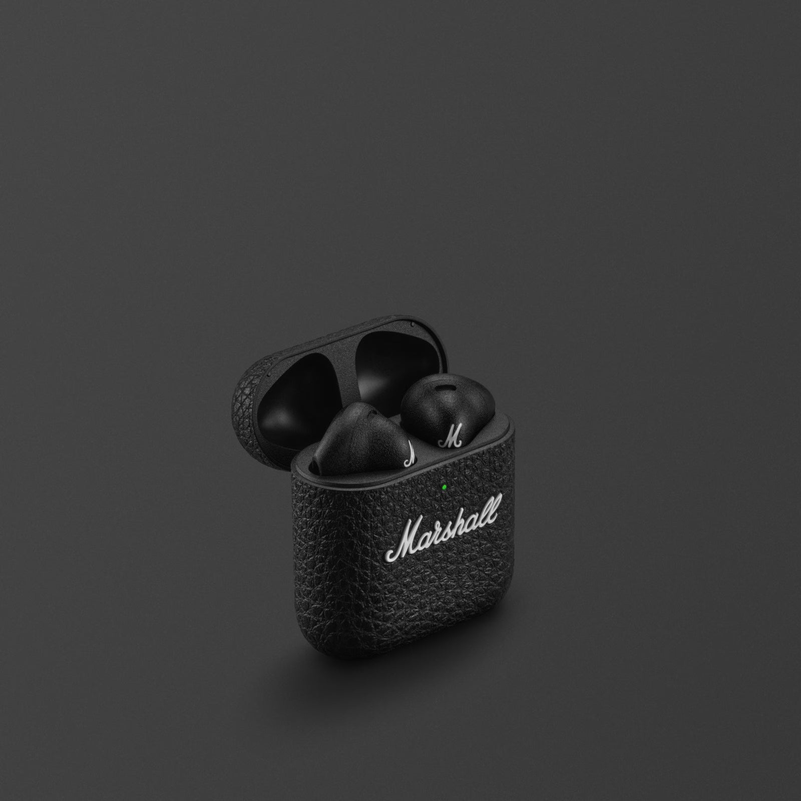 Black wireless earbuds in a case with 'Marshall' branding on a dark background