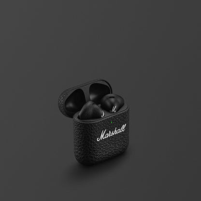 Black wireless earbuds in a case with 'Marshall' branding on a dark background