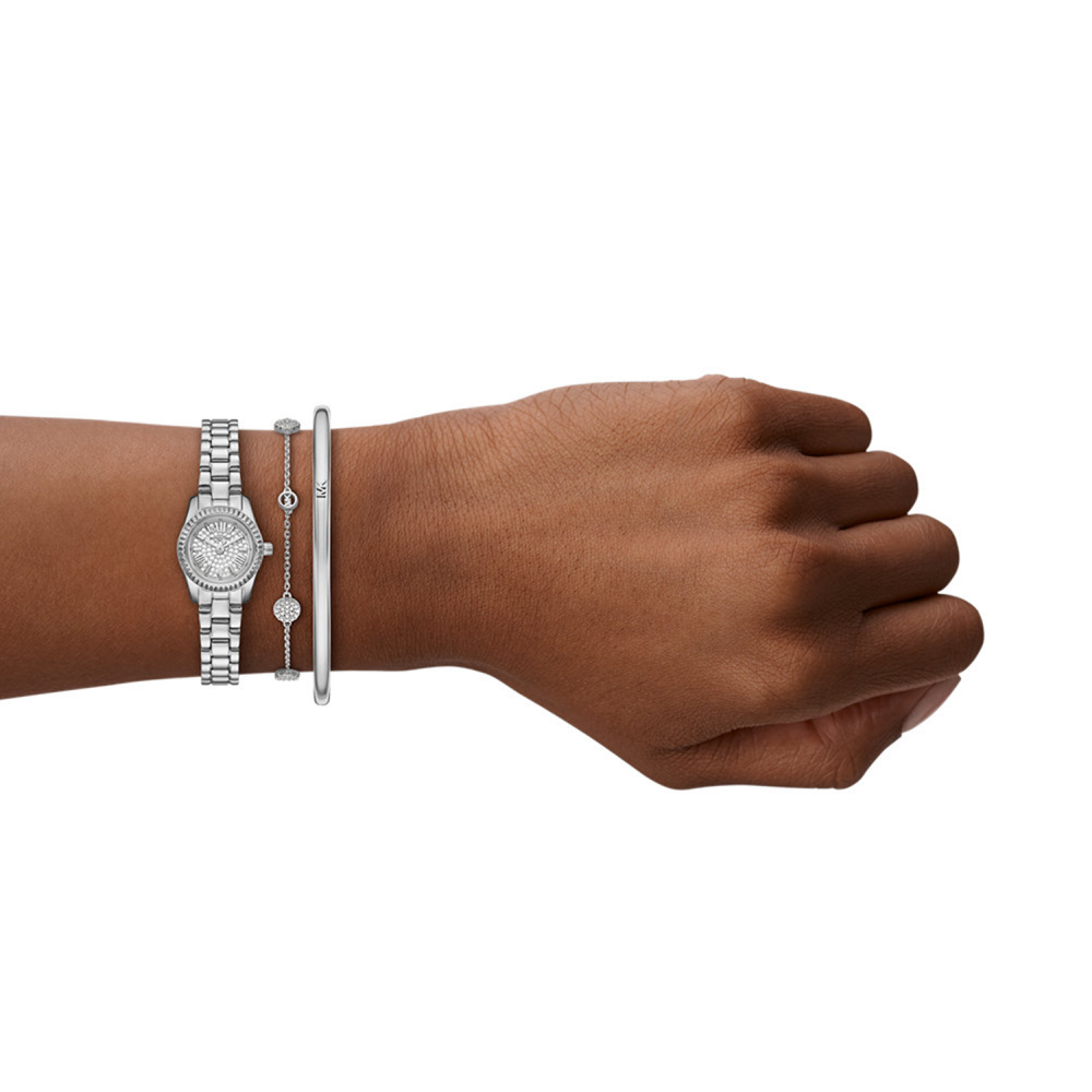 Hand wearing a silver watch and bracelets on a white background