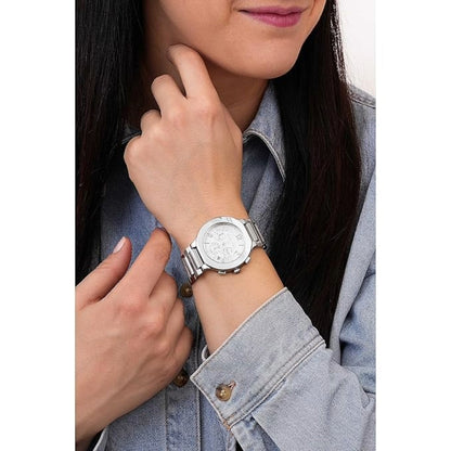 Person wearing a silver watch on a white background
