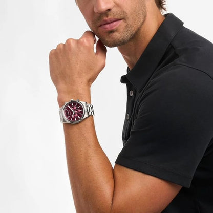 Man wearing a black polo shirt and a watch with a red face on a white background