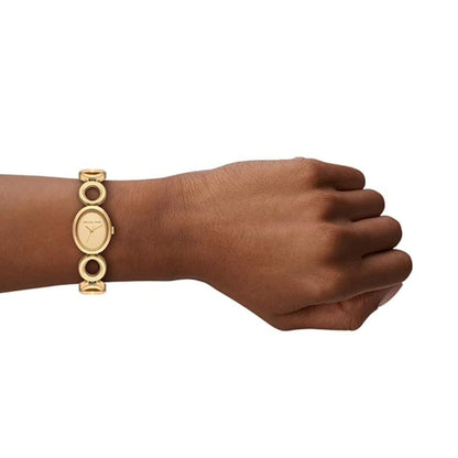 Gold bracelet on a wrist against a white background