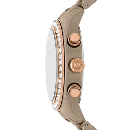 Close-up of a Michael Kors watch with rose gold and beige accents on a white background