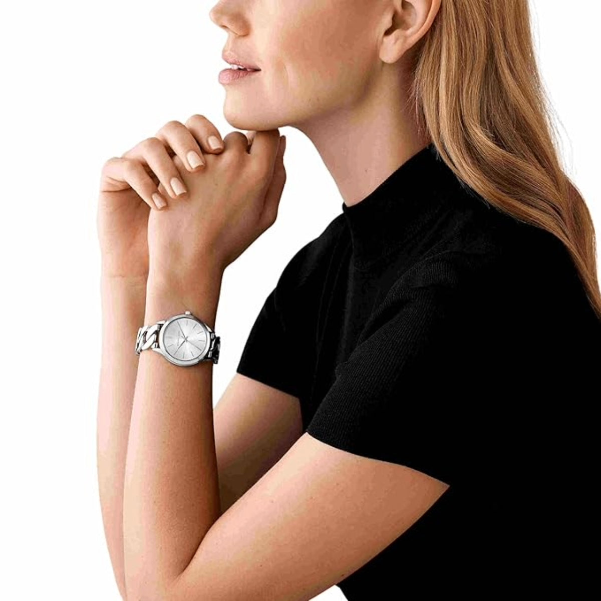 Woman wearing a silver watch on a white background