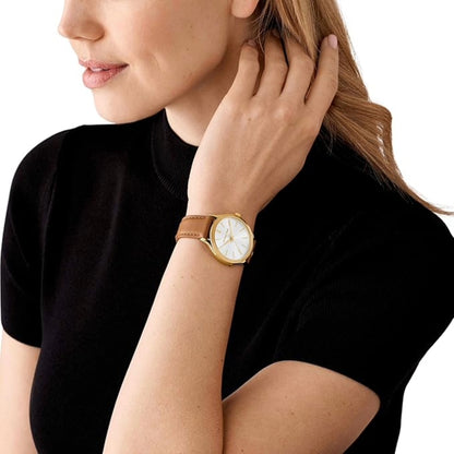 Woman wearing a gold watch on a white background