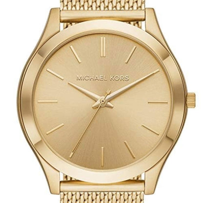 Gold watch with 'Michael Kors' branding on a white background