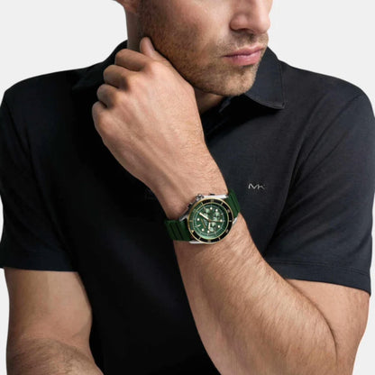 Man wearing a black polo shirt with a green watch on his wrist.