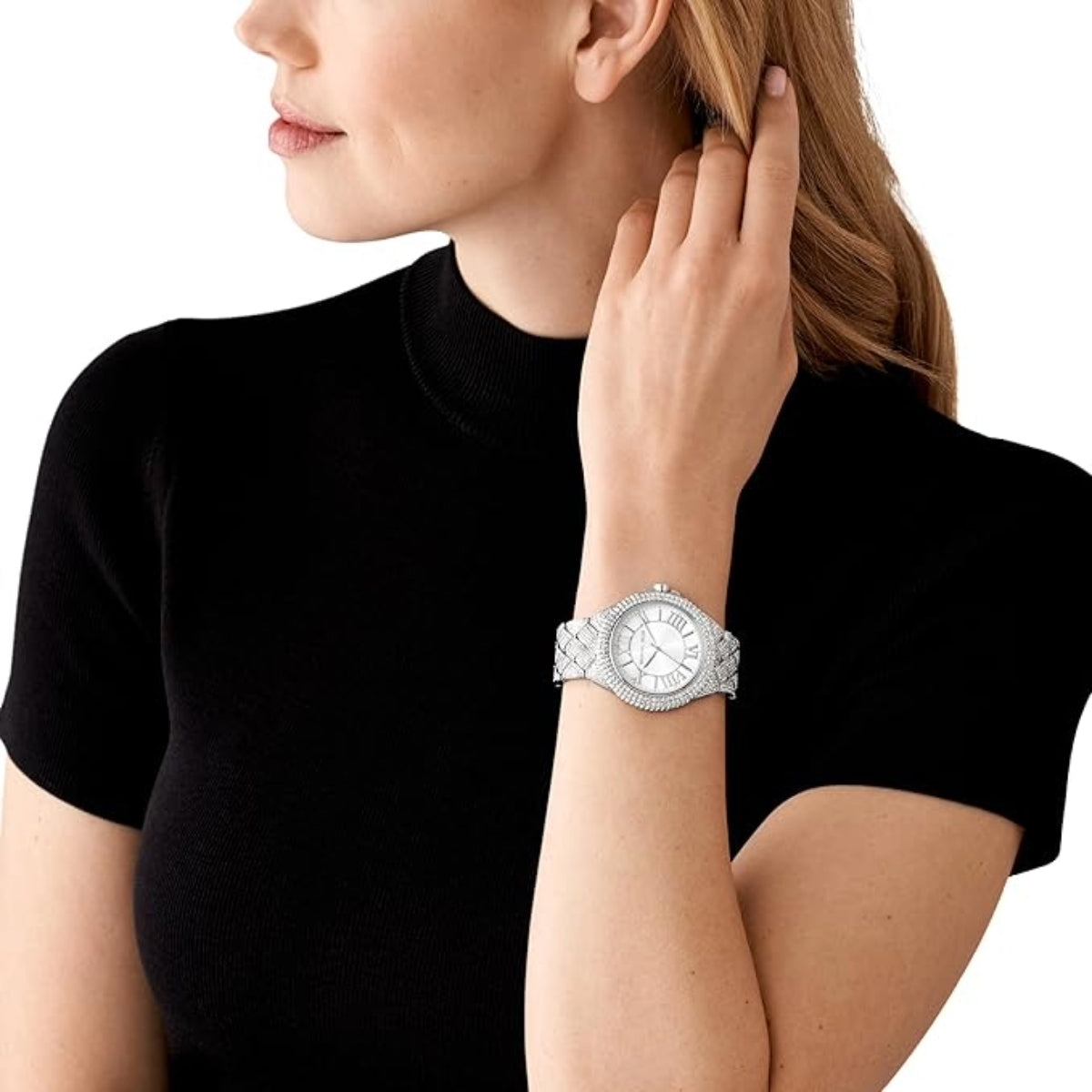 Woman wearing a silver watch on a white background