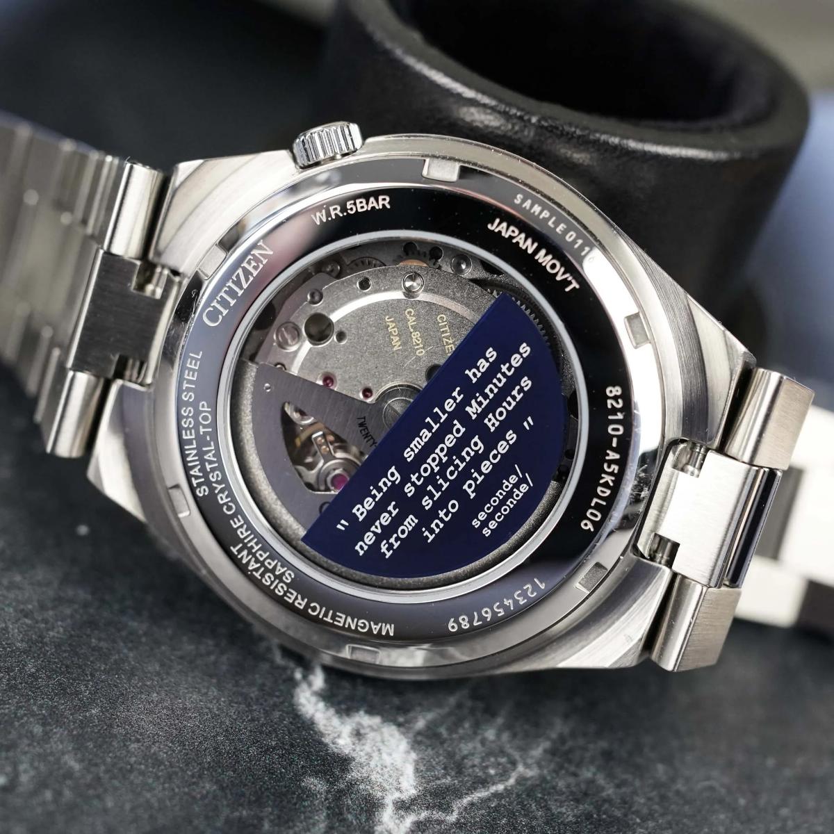 Close-up of a Citizen watch with visible mechanical components and text on a dark background