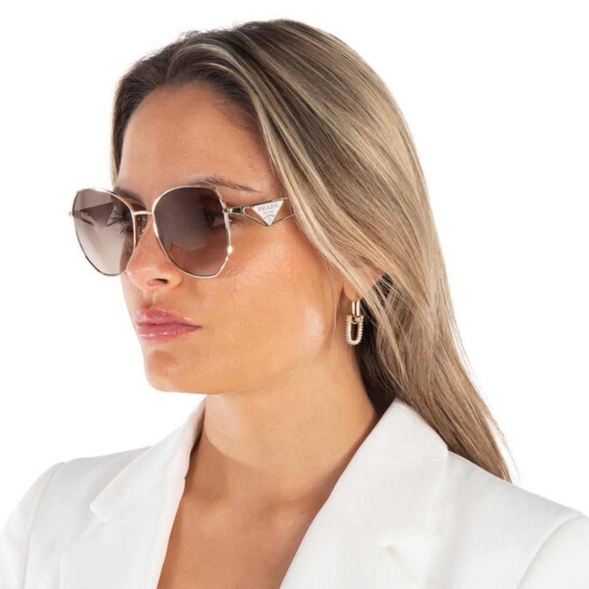 Woman wearing stylish sunglasses and a white blazer on a white background
