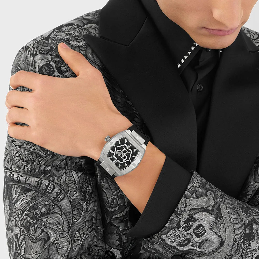 Person wearing a silver watch with a unique face, dressed in a black shirt with a patterned design.